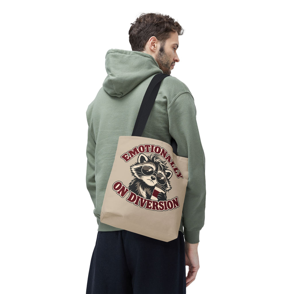 Emotionally on Diversion raccoon tote with Black handles, worn over a man's shoulder