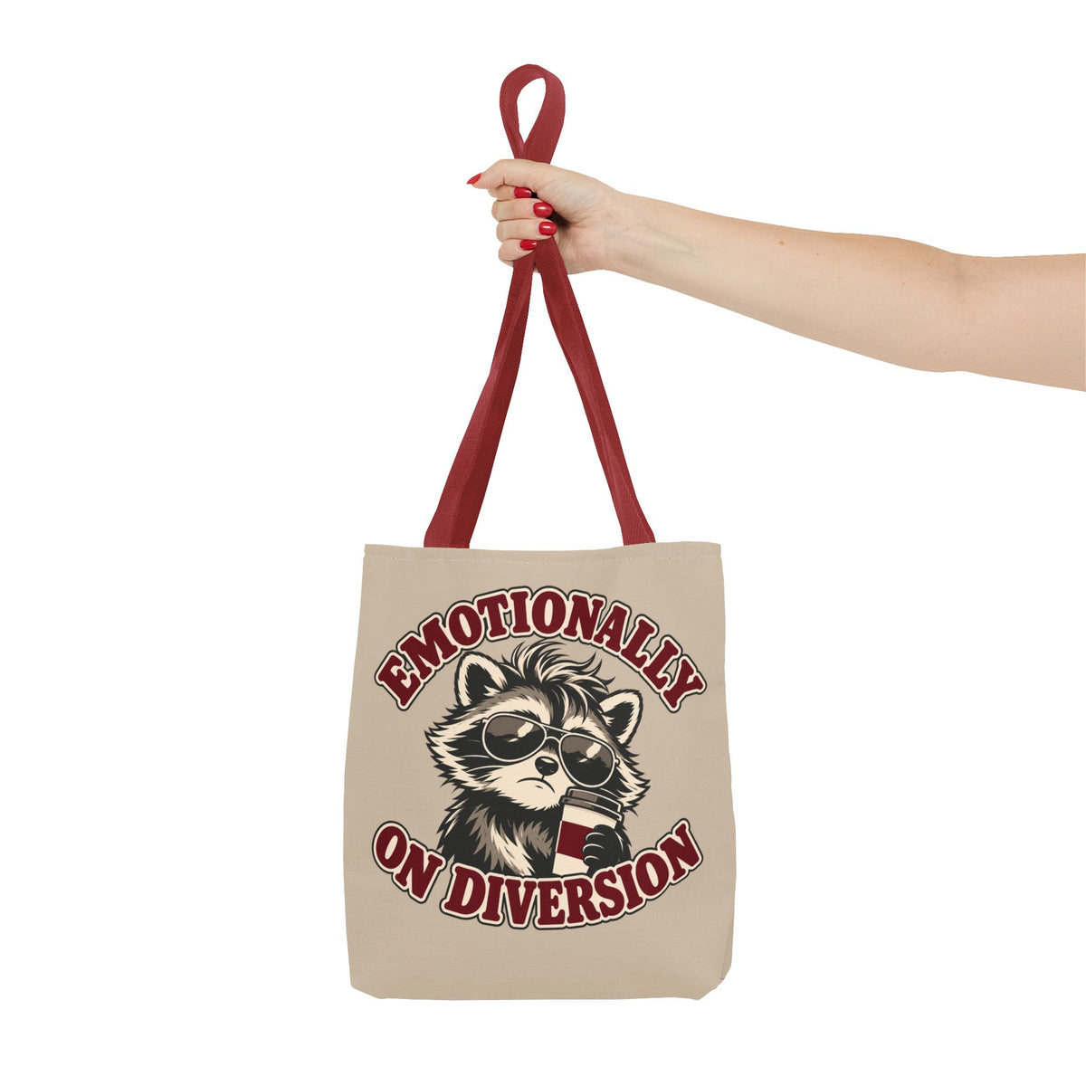 Emotionally on Diversion raccoon tote with Red handles, held on an arm