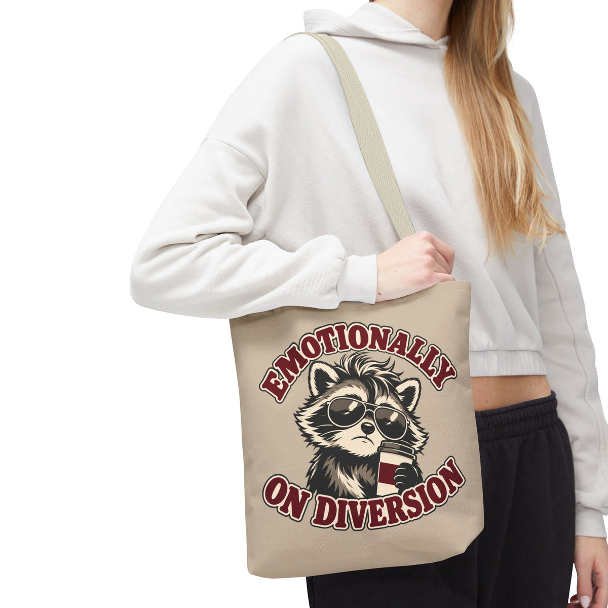 Emotionally on Diversion raccoon tote with Beige handles, worn over a woman's shoulder