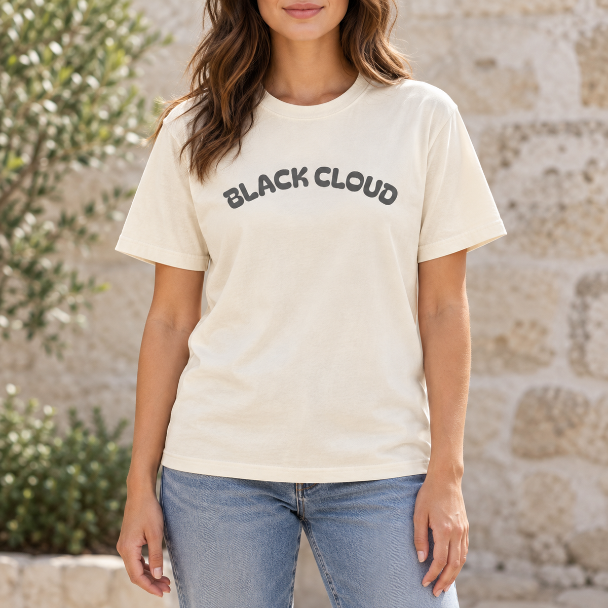 Woman wearing the Ivory Black Cloud graphic T-shirt outdoors