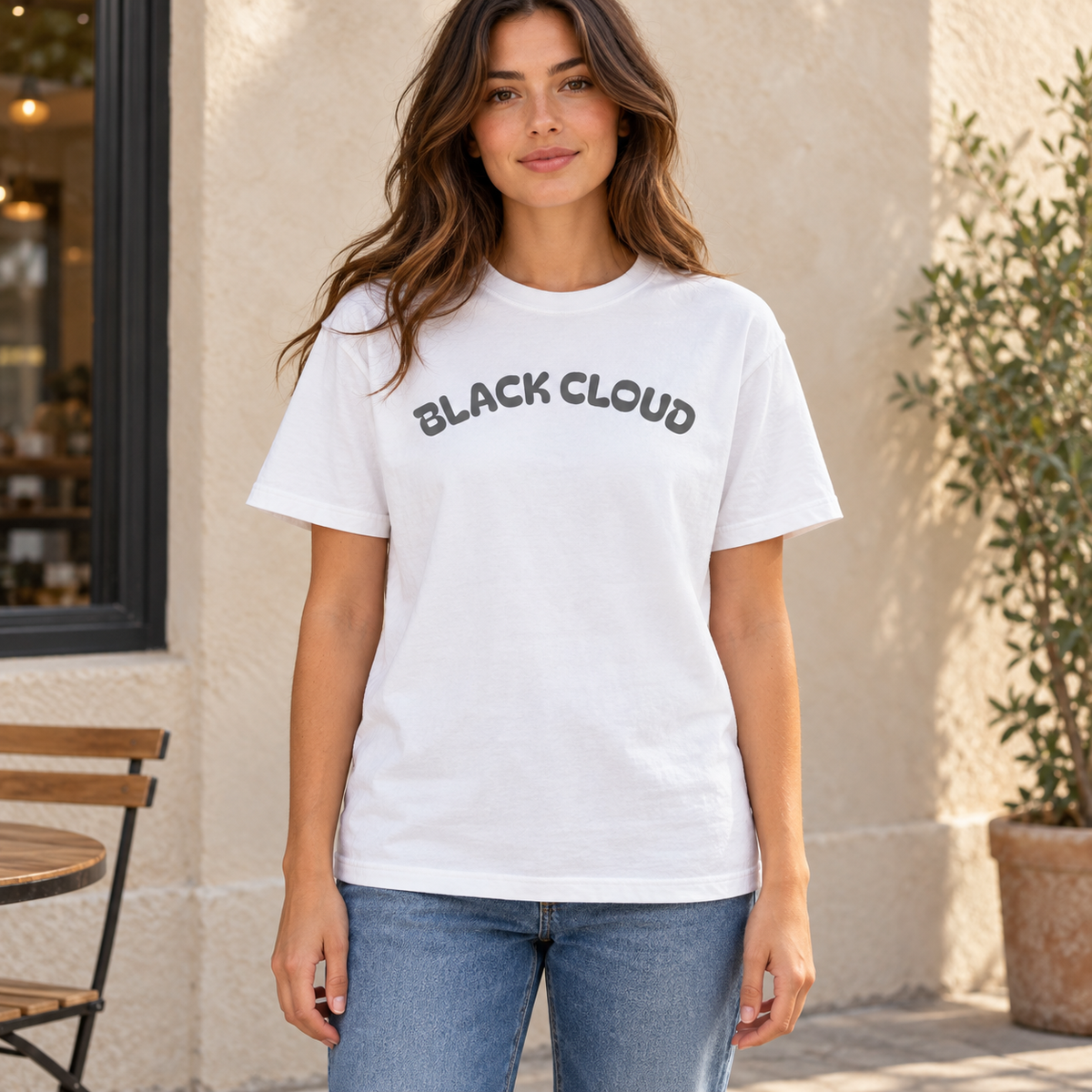 Woman wearing White Black Cloud graphic cotton T-shirt outdoors