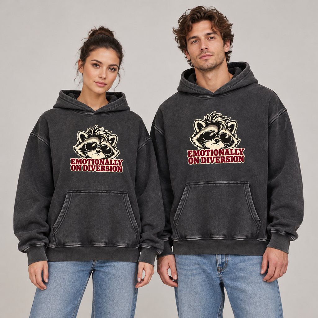 Man and woman wearing the Black Emotionally on Diversion oversized raccoon hoodie