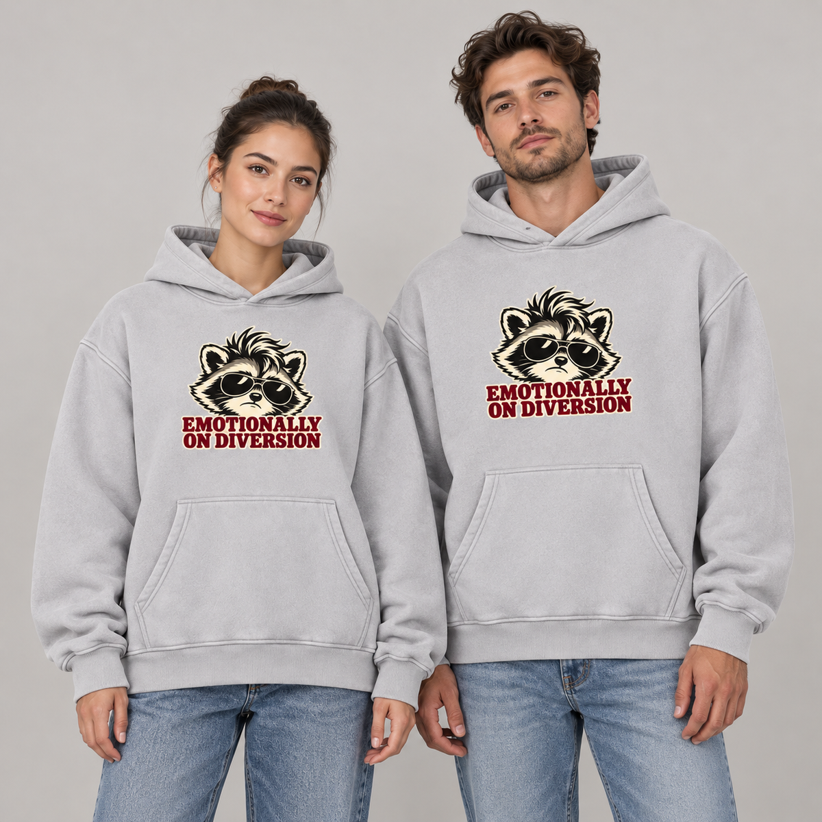 Man and woman wearing the Light Gray Emotionally on Diversion oversized raccoon hoodie